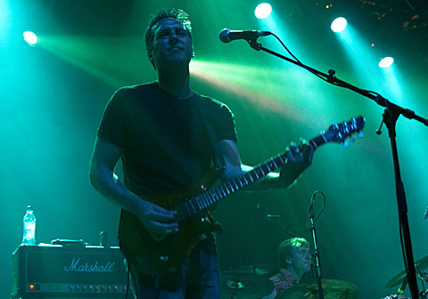 playing guitar on stage